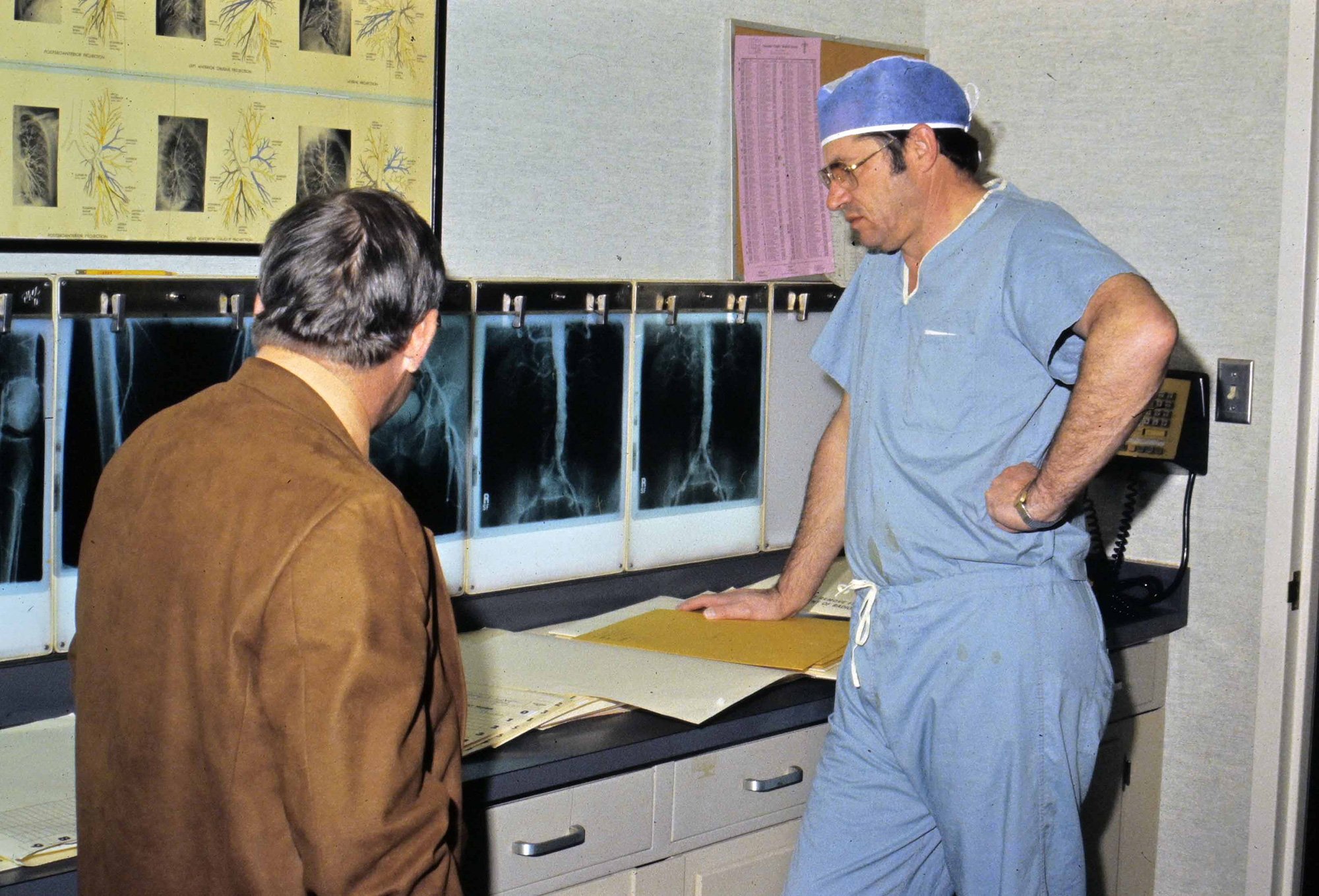 Doctor standing looking at paperwork